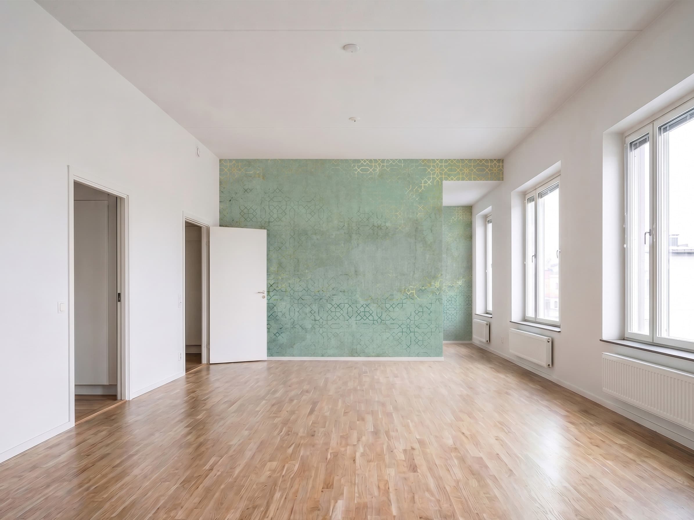 Heller Wohnraum mit grün gemusterter Fototapete auf der Stirnwand und Parkettboden